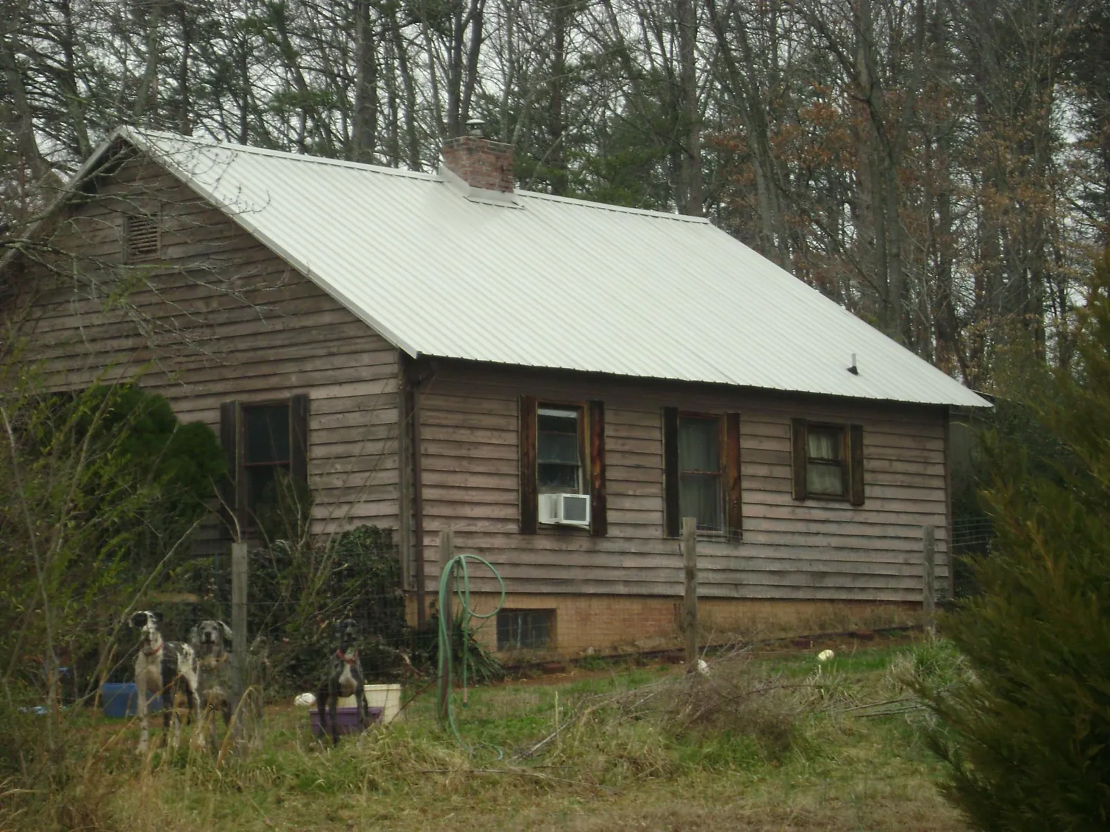 White metal roof on an old wood sided farmhouse, from a Metal Roof Installation job in Locust Hill